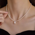 Woman wearing a synthetic pearl pendant necklace on a 925 sterling silver chain from Wearzilo