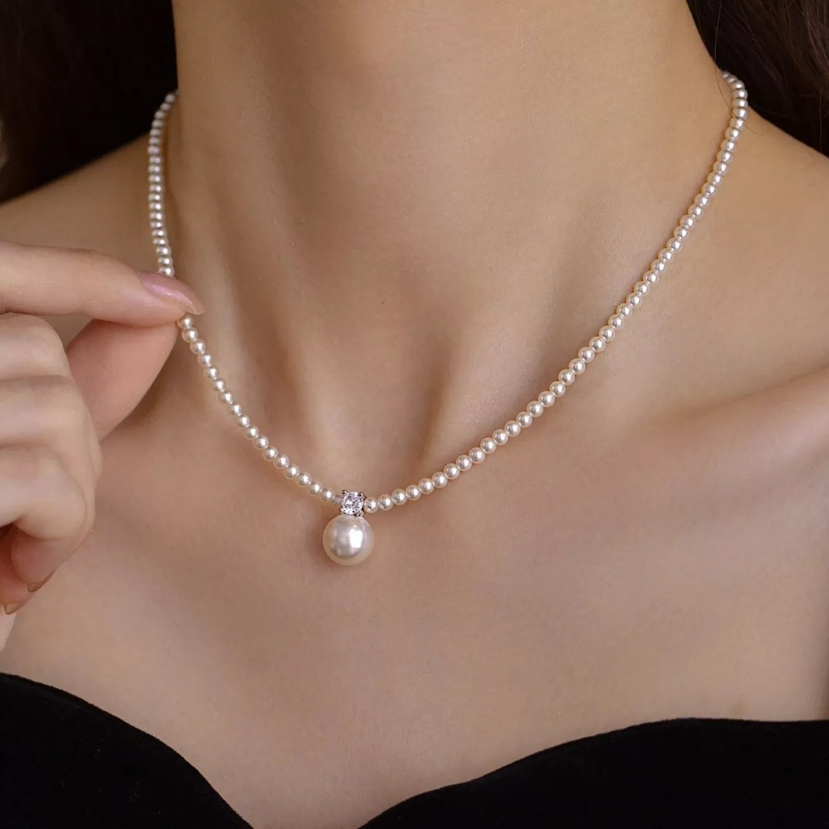 Woman wearing a synthetic pearl pendant necklace on a 925 sterling silver chain from Wearzilo