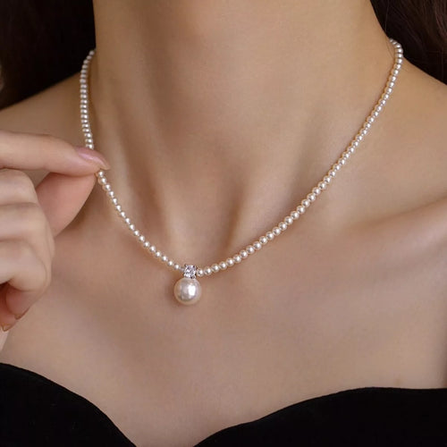 Woman wearing a synthetic pearl pendant necklace on a 925 sterling silver chain from Wearzilo